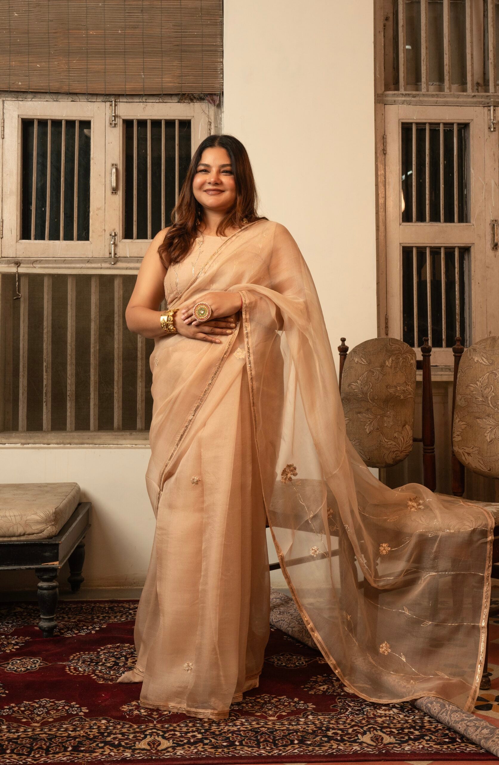 Shop Zebein’s Women’s Organza Silk Gulaab Baag Saree in Swarn Beige, thoughtfully crafted in luxurious organza silk with graceful drape and refined detailing. Designed for festive celebrations, wedding occasions, and elevated ethnic styling, this timeless saree blends lightweight elegance, sophisticated craftsmanship, and contemporary tradition for effortless statement dressing.