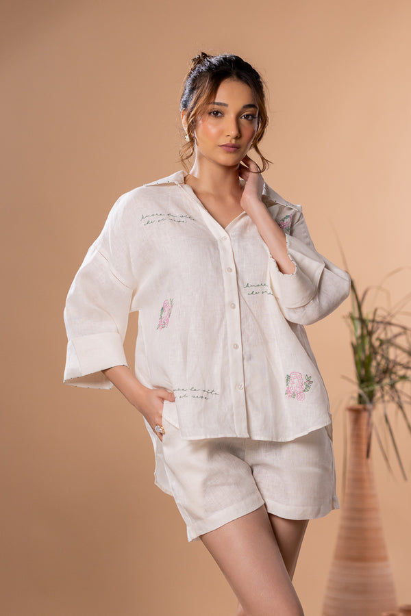Women’s off-white 100% pure linen oversized backloop shirt with scattered hand embroidery, wide sleeves, button-down front, and relaxed summer silhouette.