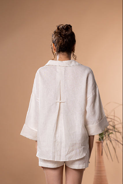 Women’s off-white 100% pure linen oversized backloop shirt with scattered hand embroidery, wide sleeves, button-down front, and relaxed summer silhouette.