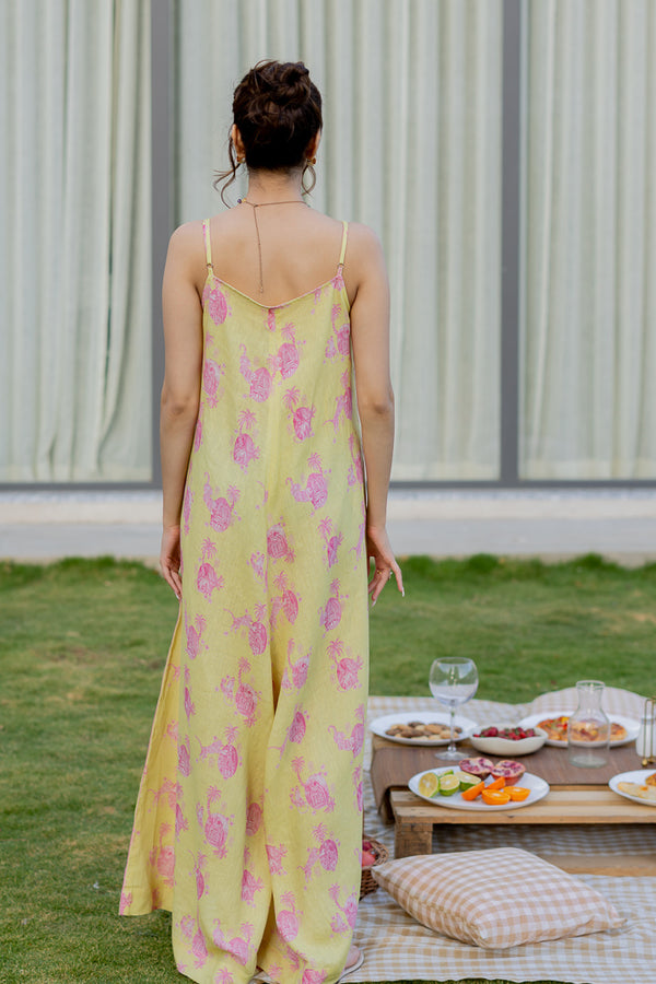 Model wearing Zebein’s Women’s 100% Pure Linen Strap Jumpsuit in yellow and pink print, featuring a relaxed silhouette, breathable sustainable linen fabric, functional pockets, and an effortlessly elegant contemporary style.